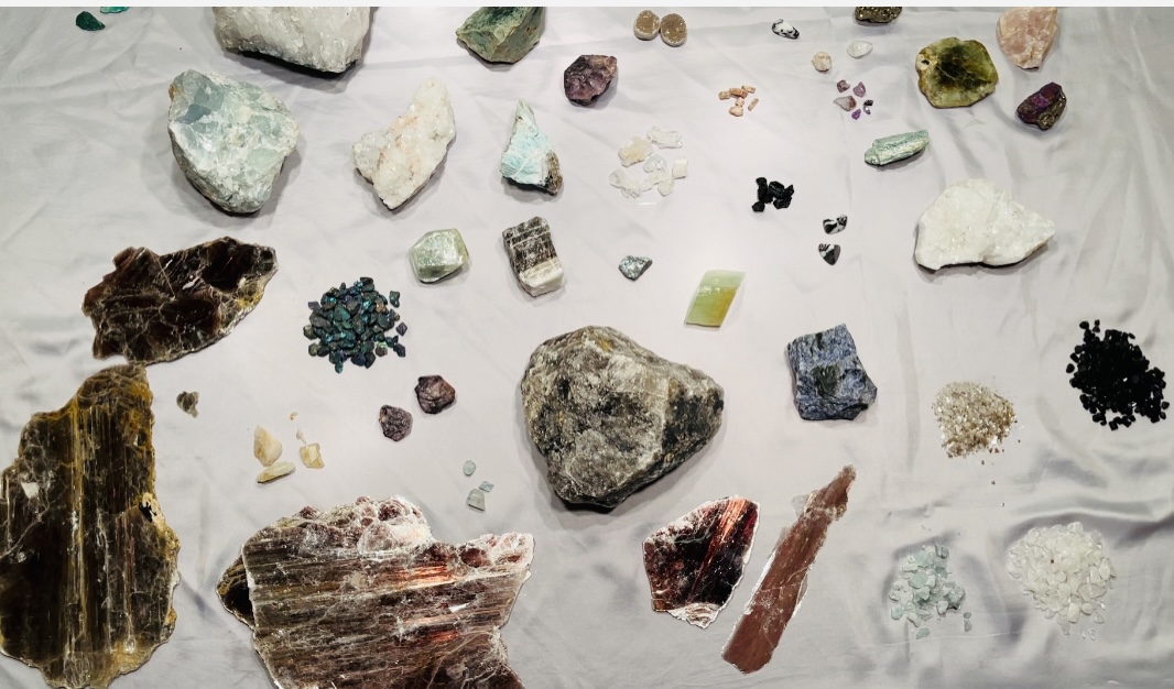 Overview photo of gemstones and minerals of varying shapes, sizes, and colors.