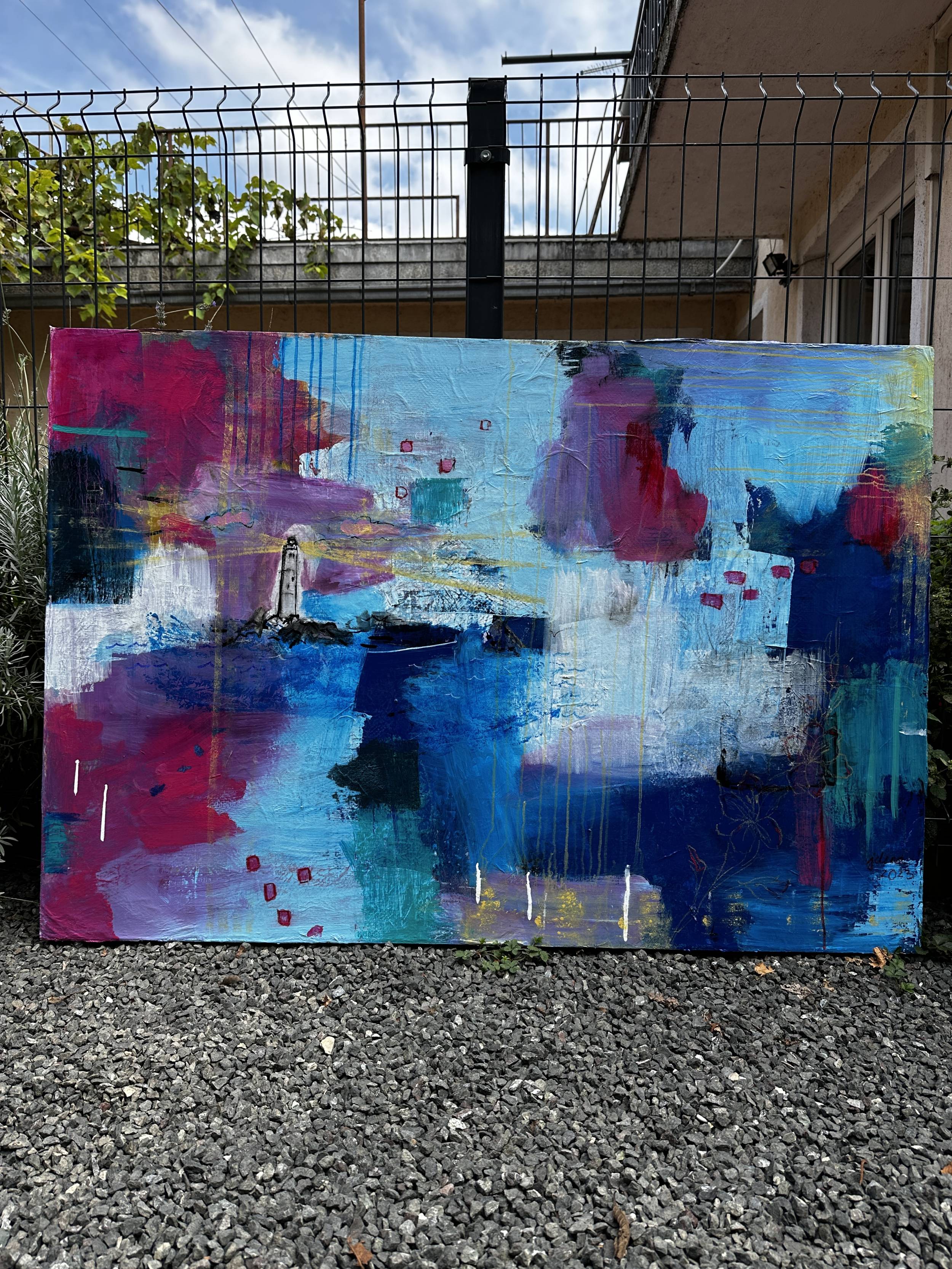 Jelena Martinović's piece "Lighthouse of Love," which features a lighthouse surrounded by bright blues, pinks, greens and yellows