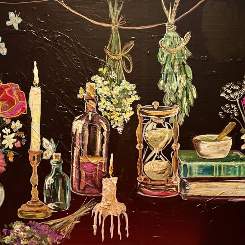 Artist Jacqueline Carmody's piece, "Sarah's Apothecary," which features flowers, candles, bottles, books and an hourglass on a table.